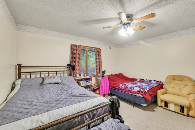 bedroom with ceiling fan, a textured ceiling, and carpet floors