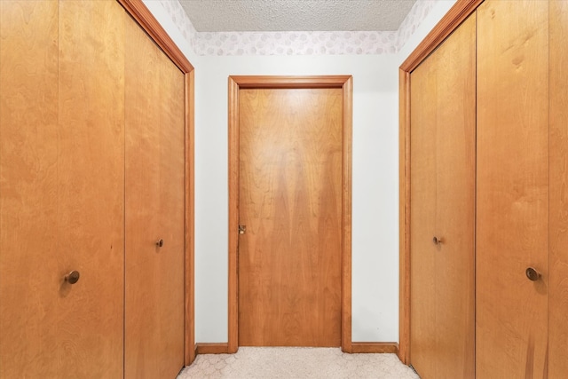 corridor featuring a textured ceiling