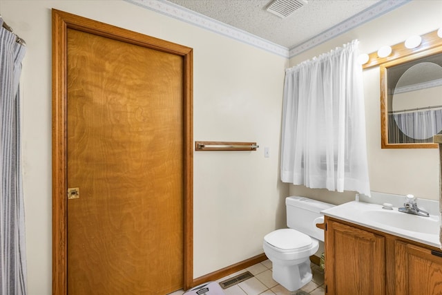 bathroom with toilet, vanity, a textured ceiling, and tile patterned floors