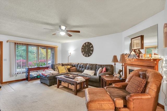 carpeted living room with ceiling fan and a textured ceiling