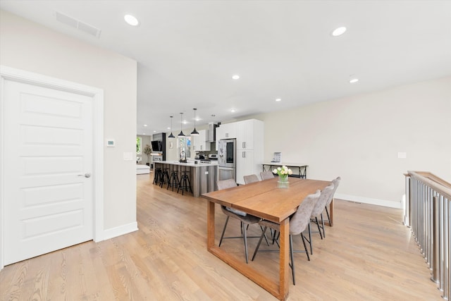 dining area with light hardwood / wood-style floors