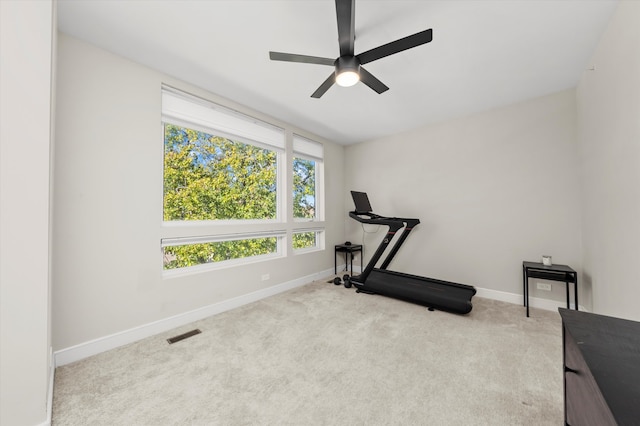 workout room with light colored carpet and ceiling fan