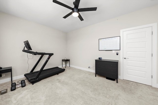 exercise area with light colored carpet and ceiling fan