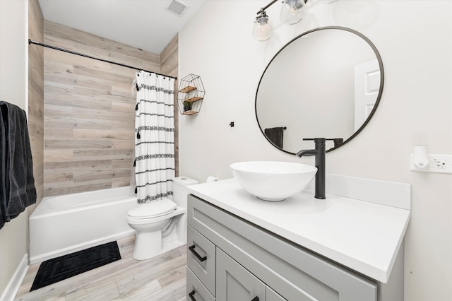 full bathroom with wood-type flooring, vanity, toilet, and shower / tub combo