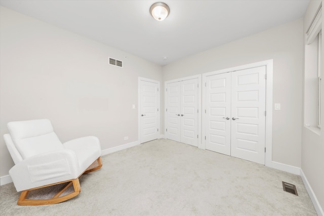 sitting room with light colored carpet