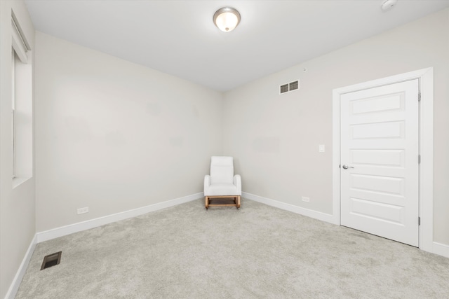 unfurnished room featuring light colored carpet