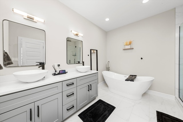 bathroom with vanity and shower with separate bathtub