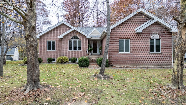 single story home featuring brick siding and a front yard