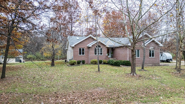 ranch-style house with brick siding, heating fuel, and a front yard