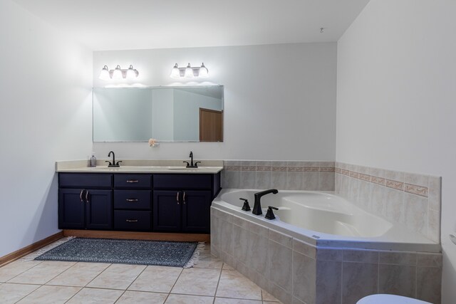 bathroom with vanity, a relaxing tiled tub, and tile patterned floors