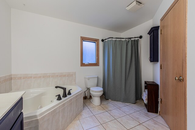 bathroom featuring tile patterned flooring, tiled bath, vaulted ceiling, toilet, and vanity