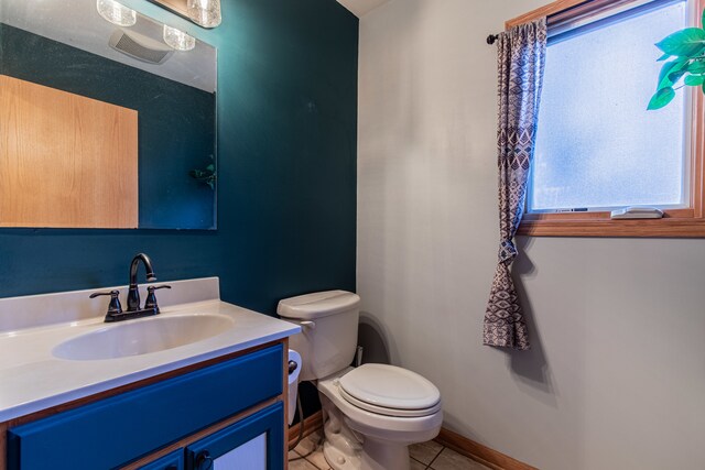 bathroom featuring tile patterned flooring, vanity, and toilet