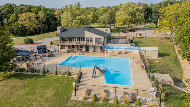 view of pool with a yard, a patio, and a water slide