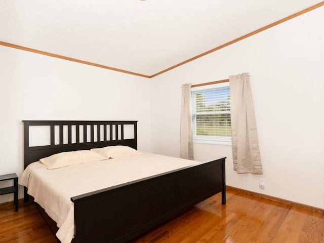 bedroom featuring hardwood / wood-style floors and crown molding