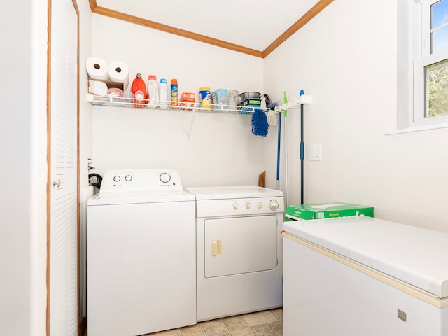 clothes washing area with ornamental molding and washer and clothes dryer