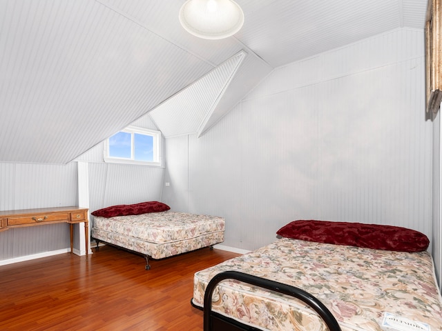 bedroom featuring wood-type flooring and lofted ceiling