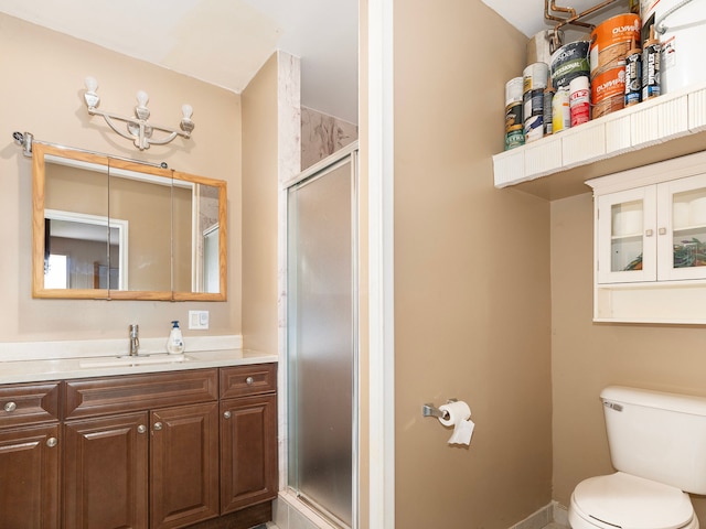 bathroom with walk in shower, vanity, and toilet