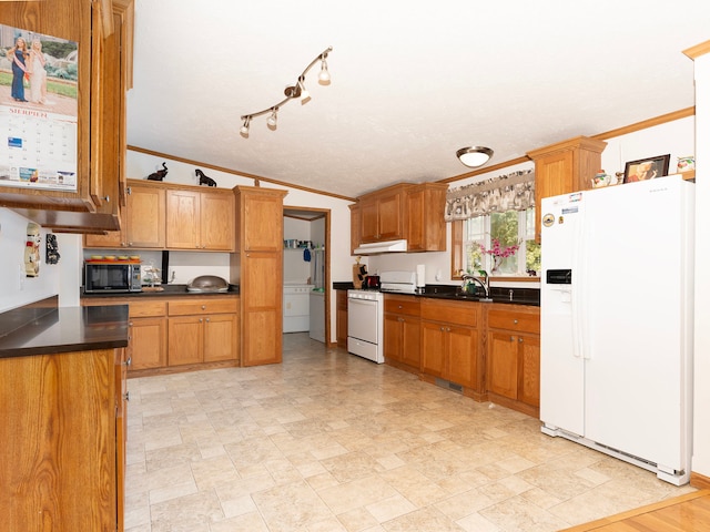 kitchen with sink, washer / clothes dryer, white appliances, crown molding, and vaulted ceiling