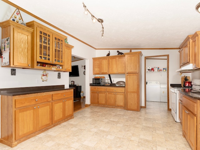 kitchen with washer and clothes dryer, white range with gas stovetop, lofted ceiling, and crown molding