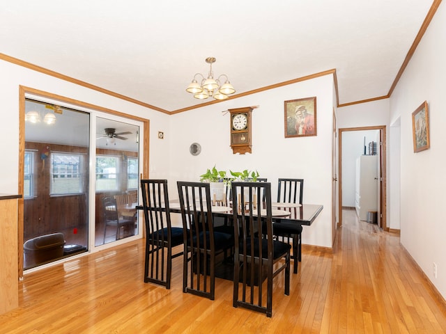 dining room featuring light hardwood / wood-style floors, ceiling fan with notable chandelier, and ornamental molding