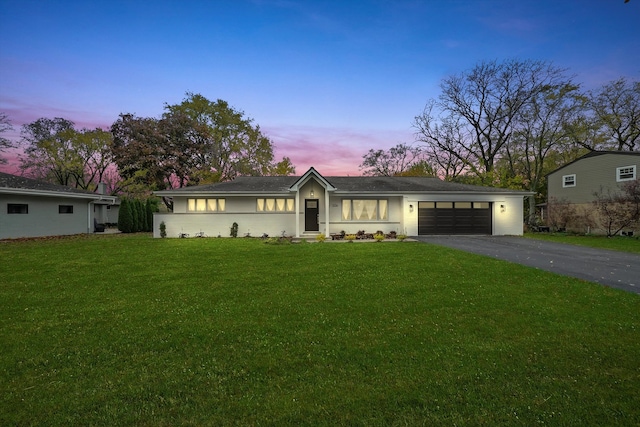 ranch-style house with a lawn and a garage