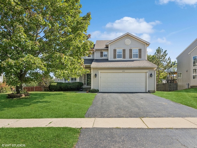 view of front of house with a garage and a front yard