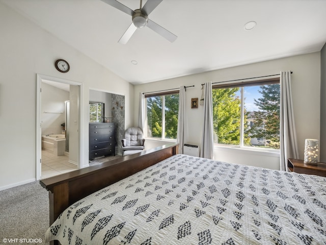 bedroom featuring vaulted ceiling, light colored carpet, ceiling fan, and ensuite bath