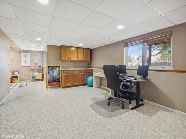 carpeted office with a drop ceiling