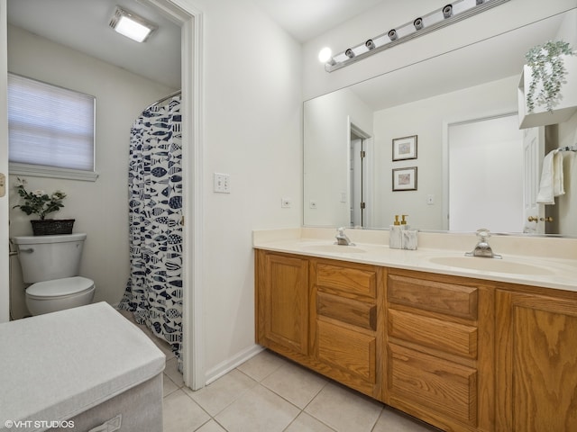 bathroom with tile patterned flooring, vanity, and toilet