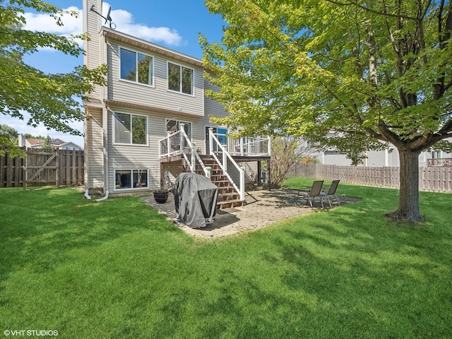 rear view of property with a lawn and a wooden deck