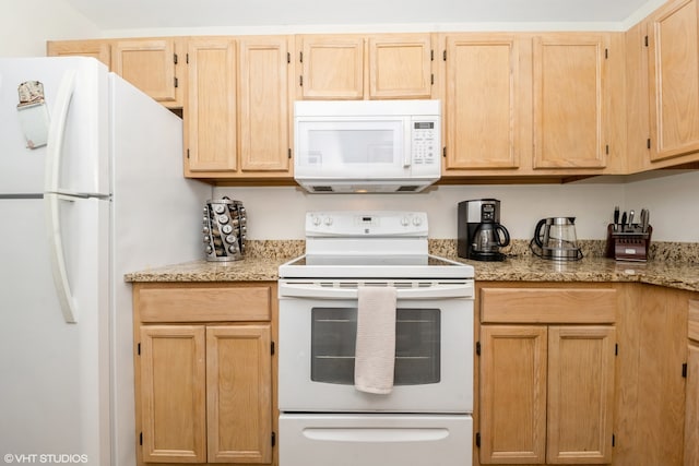 kitchen with light stone counters, light brown cabinetry, and white appliances