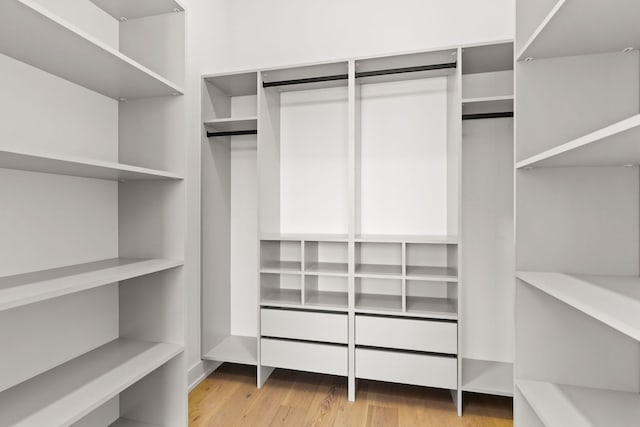 spacious closet with light hardwood / wood-style floors