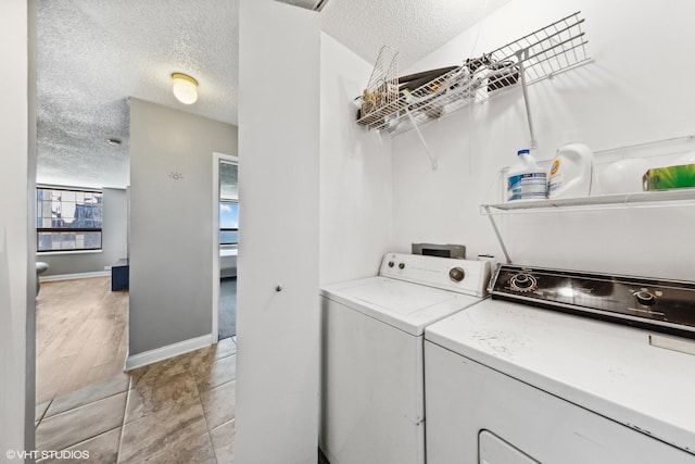 474 N Lake Shore Dr Unit 3303, Chicago, IL 60611 - laundry area with independent washer and dryer, a textured ceiling, and baseboards