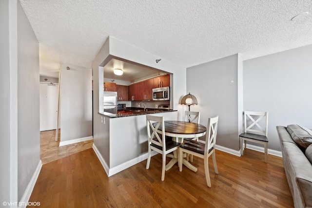 474 N Lake Shore Dr Unit 3303, Chicago, IL 60611 - kitchen with appliances with stainless steel finishes, wood finished floors, a textured ceiling, a sink, and baseboards