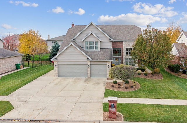 front of property featuring a front lawn and a garage