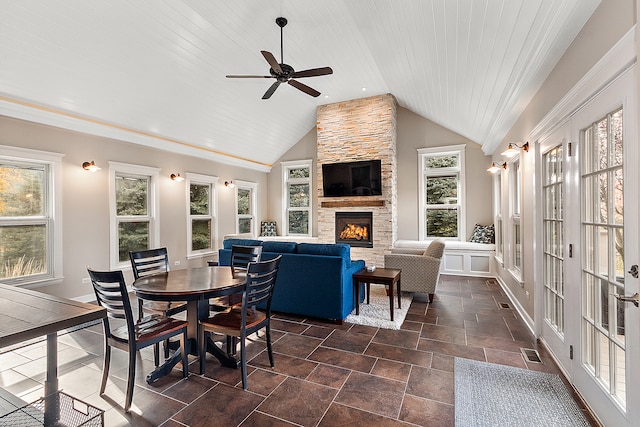 dining area featuring french doors, lofted ceiling, wood ceiling, ceiling fan, and a fireplace