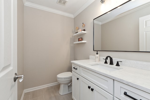 bathroom featuring crown molding, vanity, and toilet