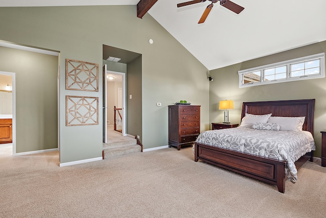 bedroom with connected bathroom, high vaulted ceiling, beamed ceiling, light colored carpet, and ceiling fan