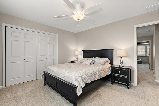 carpeted bedroom with ceiling fan and a closet