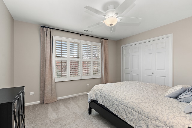 carpeted bedroom featuring a closet and ceiling fan