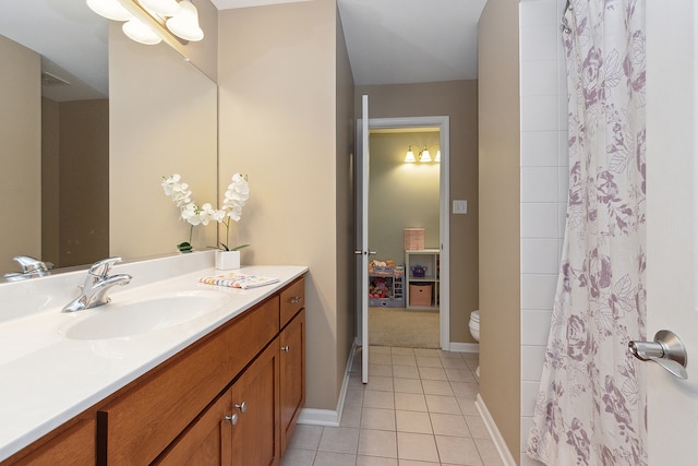 bathroom featuring vanity, tile patterned floors, and toilet