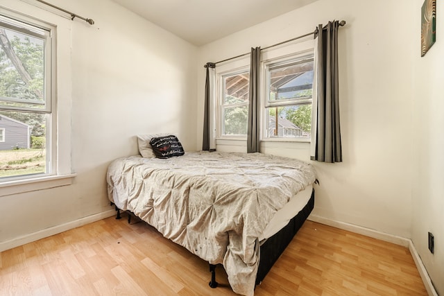 bedroom featuring wood-type flooring and multiple windows