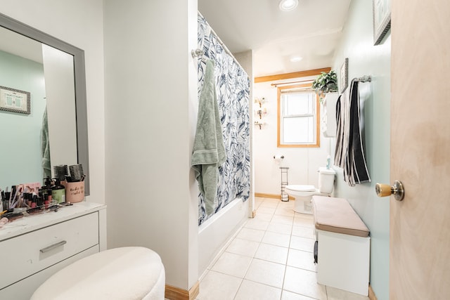 full bathroom featuring toilet, vanity, tile patterned floors, and shower / bathtub combination with curtain