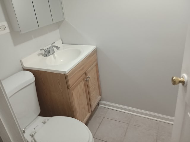 bathroom featuring tile patterned flooring, vanity, and toilet