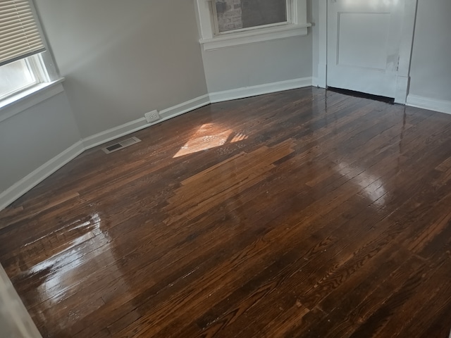 unfurnished room featuring dark hardwood / wood-style floors