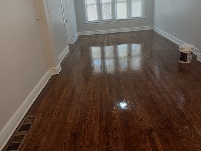 unfurnished room with dark hardwood / wood-style floors