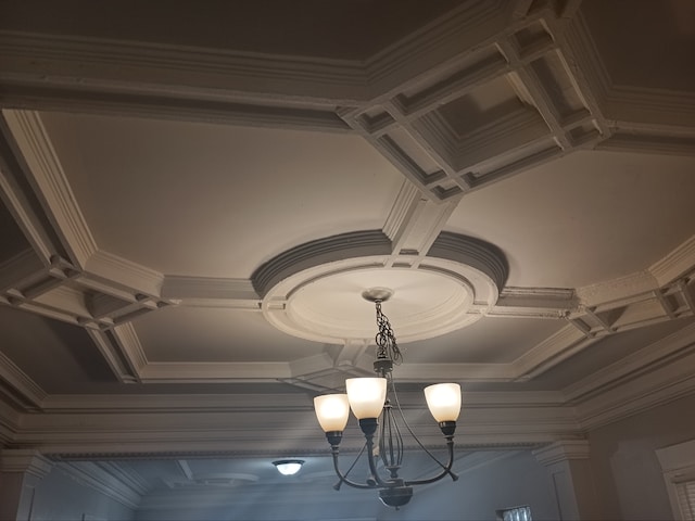 interior details featuring coffered ceiling and ornamental molding