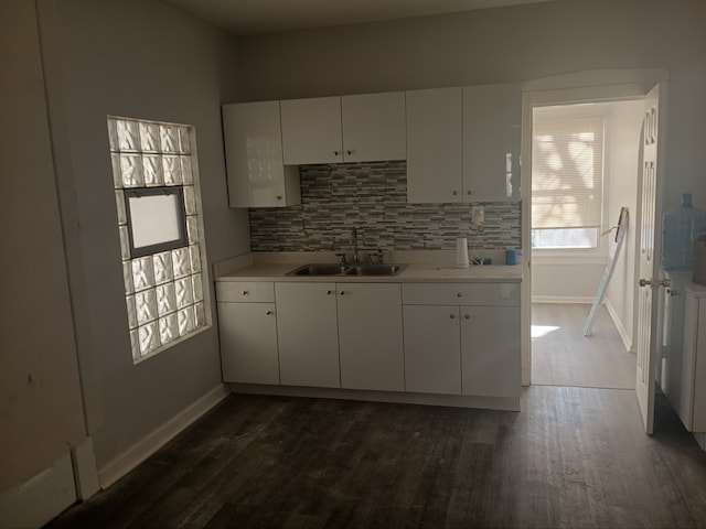 kitchen with white cabinets, dark hardwood / wood-style floors, sink, and tasteful backsplash