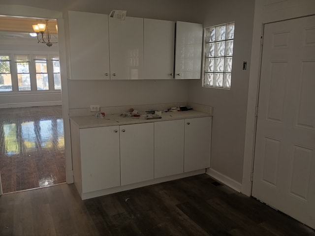 kitchen featuring white cabinets, dark hardwood / wood-style flooring, and a chandelier