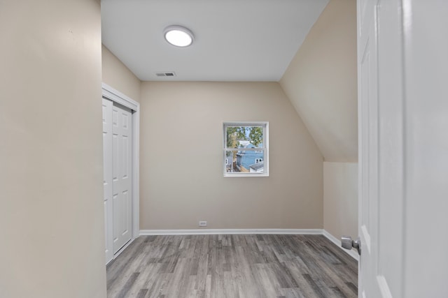 bonus room featuring vaulted ceiling and light hardwood / wood-style floors